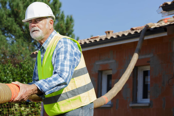 senior man working with construction pipes - Фото, зображення