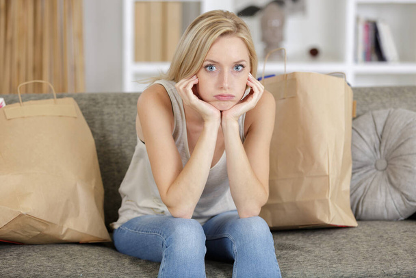 sad young pretty woman with shopping bags - Foto, Imagem