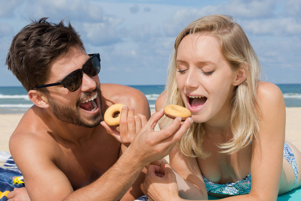 couple having a picnic on the beach - Φωτογραφία, εικόνα