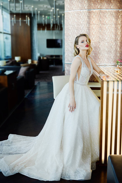 Portrait of beautiful bride wearing fashion wedding dress with luxury make-up and hairstyle indoors. Wedding concept - Fotoğraf, Görsel