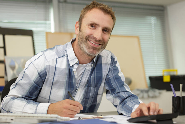 a male workshop designer smiling - Φωτογραφία, εικόνα