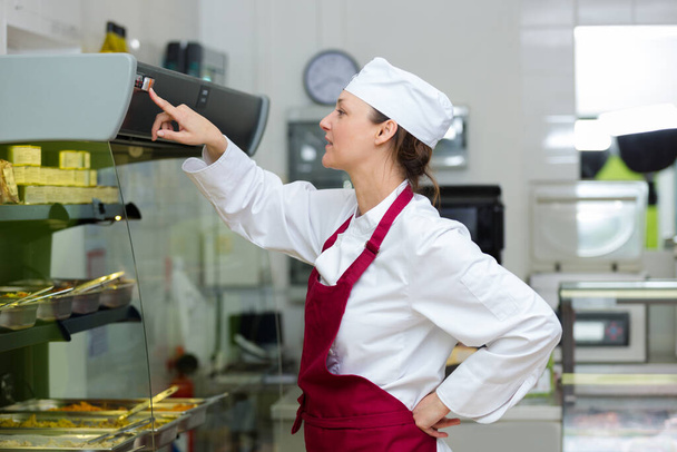 woman working at a buffet - Photo, image