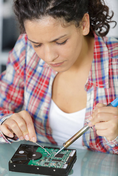 young woman technician repair electronics device toned image - Foto, Imagem