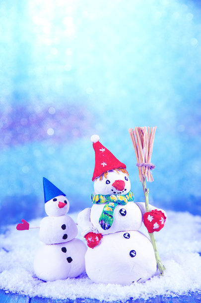 Beautiful snowmen and Christmas decor, on bright background - Photo, Image