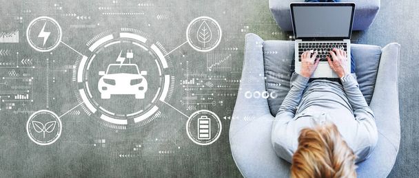 EV concept with man using a laptop - Photo, Image