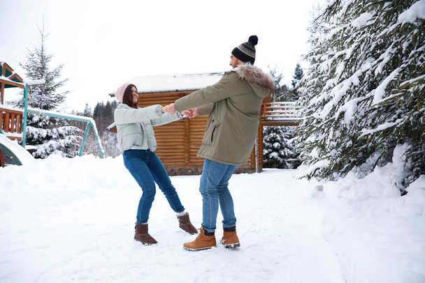 Lovely couple spending time together on snowy day. Winter vacation - Foto, Bild