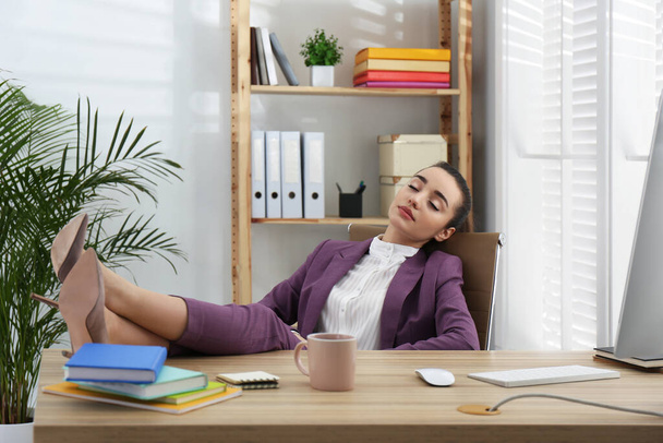 Lazy employee sleeping at table in office - Photo, image