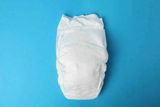 Baby diaper on blue background, top view - Fotoğraf, Görsel