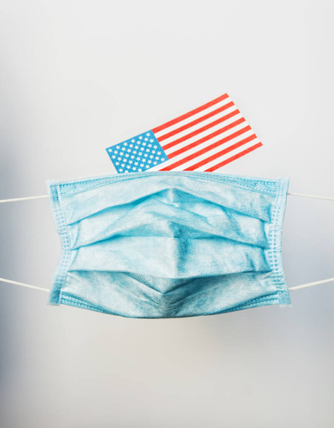 protective face mask respiratory against american flag - Coronavirus concept Pandemic in USA - 写真・画像