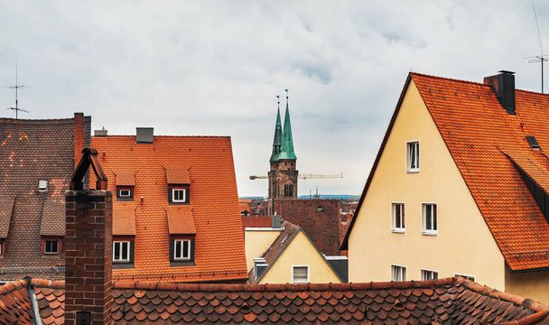 Old town architecture in German city of Nuremberg Nurnberg, Mittelfranken region, Bavaria, Germany. Terracotta and red medieval house roofs, cityscape top view from castle hill - Fotó, kép