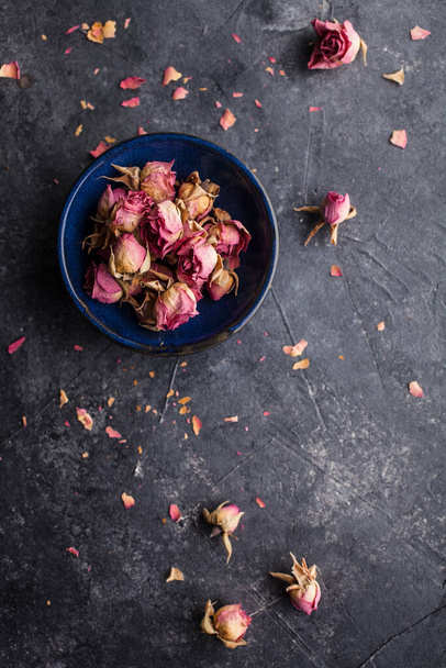 Dried pink rose buds on dark background - Fotografie, Obrázek