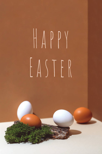 Four multi-colored eggs and natural materials moss and wood. Easter concept - Foto, Bild