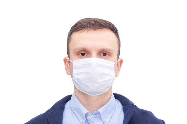Portrait of a man on a white isolated background, face covered with a medical mask, banner for text. Health, awareness, and timeliness. Healthy lifestyle. No viruses. - Foto, Imagem