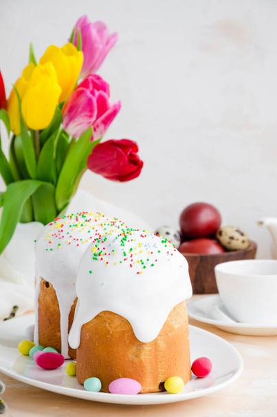 Easter composition. Easter Cake - Russian and Ukrainian Traditional Kulich with easter eggs on a light stone background. Paska Easter Bread. Selective focus. Vertical orientation. Copy space. - Photo, Image