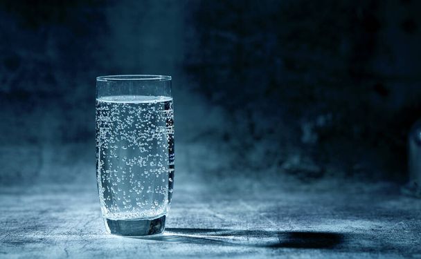 Glass of sparkling water on grey background - Photo, Image