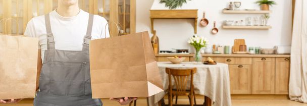 Young man delivering food to customer at doorway - Фото, зображення