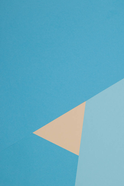 Blue and yellow background, colored paper geometrically divides into zones, frame, copy space. - Фото, зображення