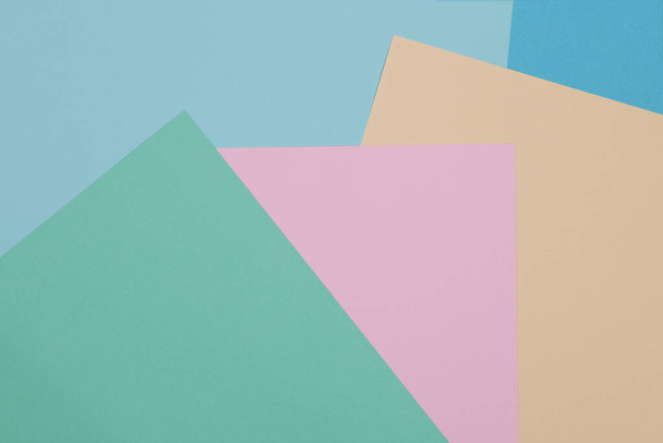 Blue, green, yellow and pink background, colored paper geometrically divides into zones, frame, copy space. - Photo, image