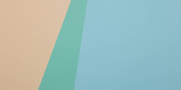 Blue, green, yellow background, colored paper geometrically divides into zones, frame, copy space. - Фото, изображение