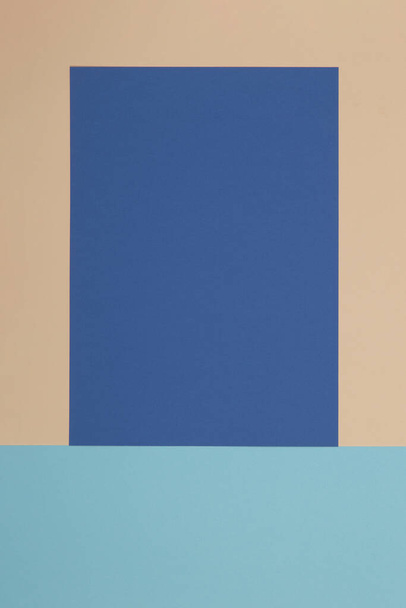Blue and yellow background, colored paper geometrically divides into zones, frame, copy space. - Foto, afbeelding
