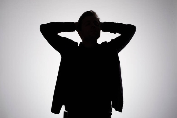 Man silhouette on gray studio wall. Anonym concept - Foto, Bild