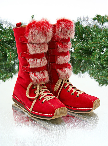 Pair of red female boots in winter decorating - Photo, Image