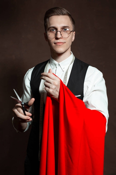 tailor man in round glasses and classic clothes with red cloth - Foto, Imagem