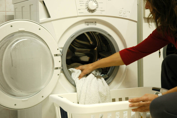 woman washing machine in the kitchen - Valokuva, kuva