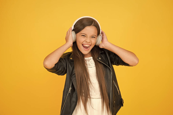 perfect party. small girl in leather jacket. autumn fashion style. child listen rock music. little school radio dj. lady DJ long hair. happy smile. hipster urban style girl. biker kid in headset - Фото, изображение