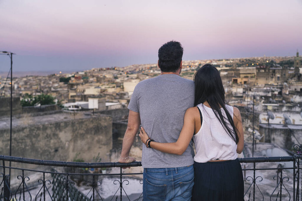 A couple enjoying the sunset of the old medina in Fez from a roof, in Morocco, Africa. - Foto, Imagem