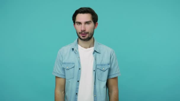 Finish, no way! Bearded guy in jeans shirt demanding to stop, crossing hands showing x sign, meaning rejection, prohibition, warning to do something. indoor studio shot isolated on blue background - Séquence, vidéo