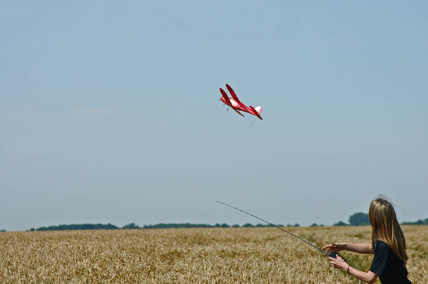 Teenager with model aircraft - Фото, изображение
