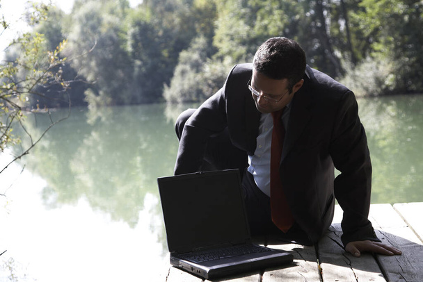 Businessman at the lake - Foto, Imagen