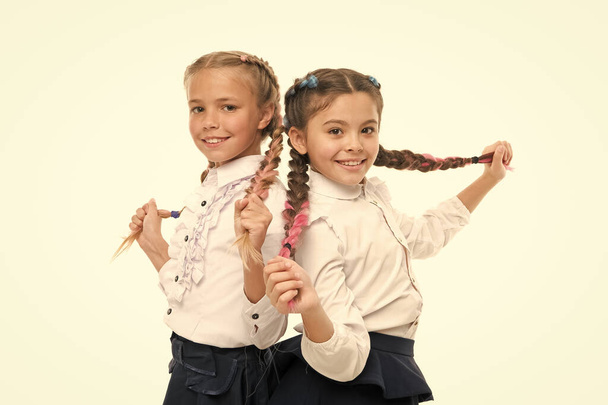 Appropriate hairstyle. Keep hair braided for tidy look. Pupils with long braided hair. Hairdresser salon. Hairstyles school style. Girls long braids. Fashion trend. It is awesome dye hair fun colors - Zdjęcie, obraz