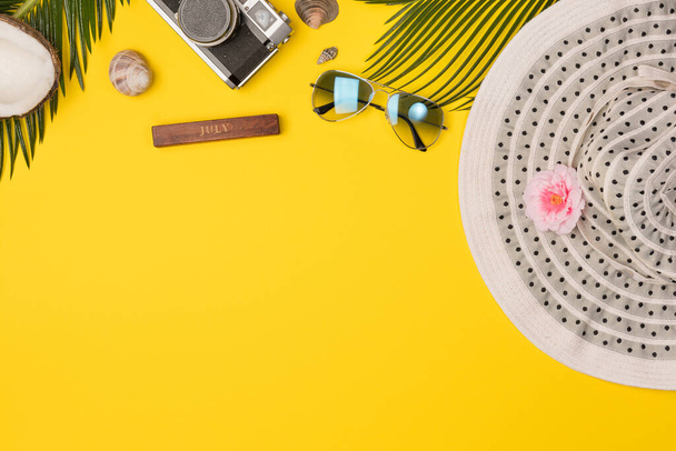 Summer composition with beach accessories, on yellow background. Top view, copy space. Flat lay. - Foto, Imagem