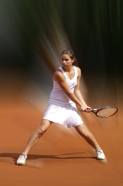 young woman playing tennis on a court - Φωτογραφία, εικόνα