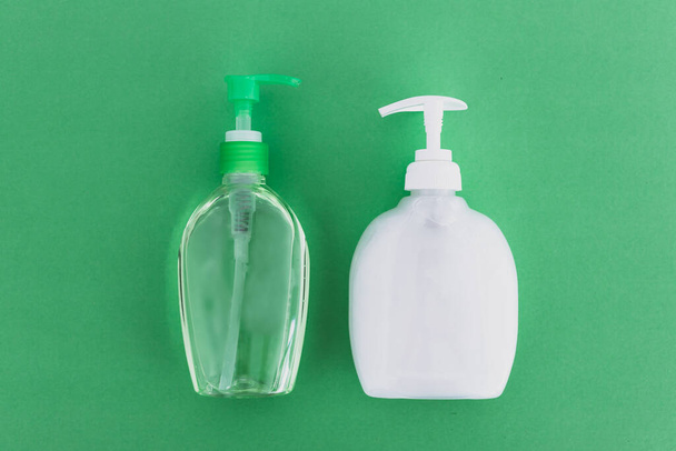 keep your hands clean to fight bacteria and viruses conceptual still-life, hand sanitizer and liquid soap and green background - Fotoğraf, Görsel