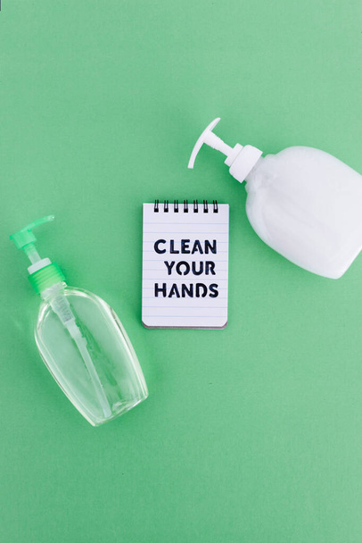 keep your hands clean to fight bacteria and viruses conceptual still-life, hand sanitizer and liquid soap next to memo with Clean your Hands text - Fotoğraf, Görsel