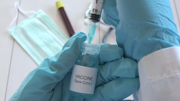 Doctor hands holding Coronavirus vaccine, nurse with blue gloves prepares Sars-CoV-2 medical remedy, scientist getting ready medicine treatment against COVID-19, 2019-nCoV vaccination  - Footage, Video