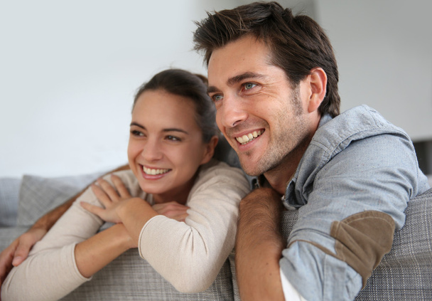 Couple at home relaxing in sofa - Foto, imagen