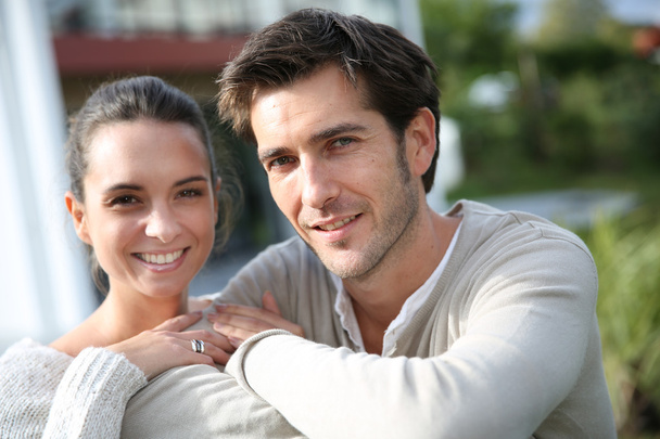 Couple standing outside in front of new home - Photo, Image