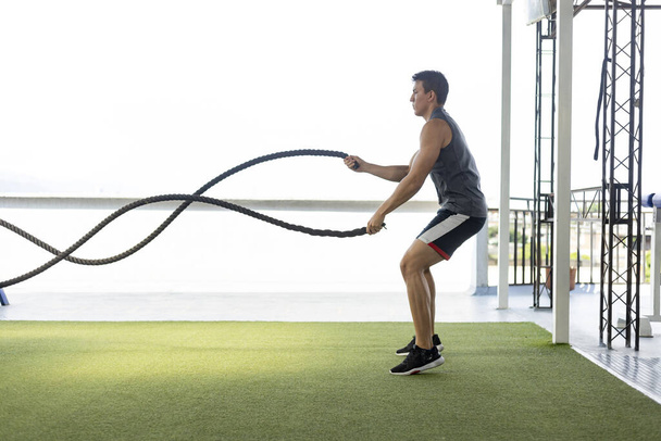 man jumping with cross fit rope - Photo, Image