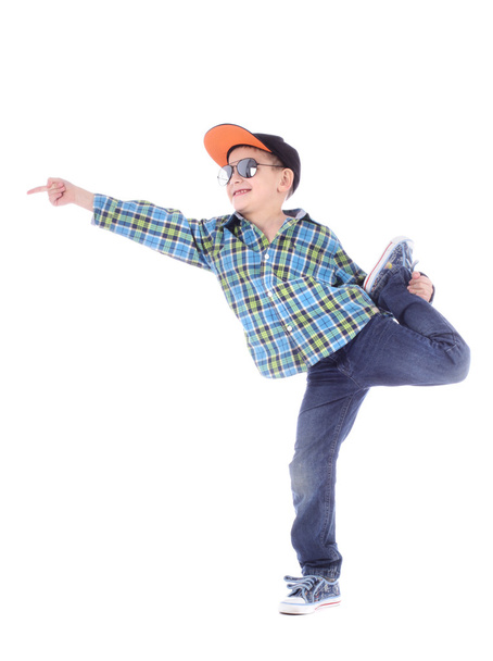 Full length portrait of smiling little boy in jeans, cup and sunglasses on white background - Photo, image