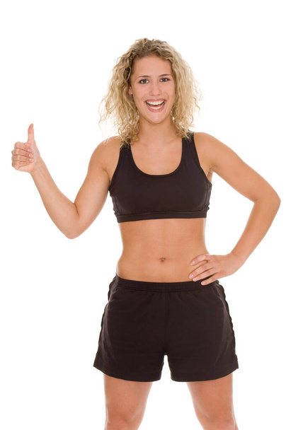 young woman in fitness outfit showing thumb up isolated on white background - Фото, изображение