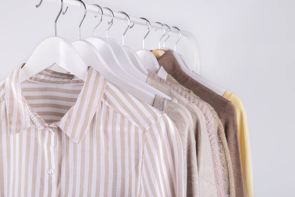 Spring female clothes hanging on a rack, trending pastel colors - Photo, image