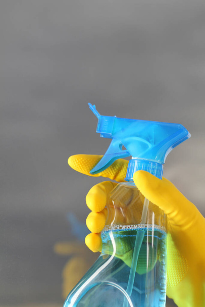 cleaning concept. woman holding spray bottle with clean green sponge and yellow gloves. - Фото, зображення