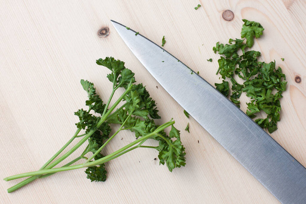 fresh green parsley on wooden cutting board - Fotó, kép