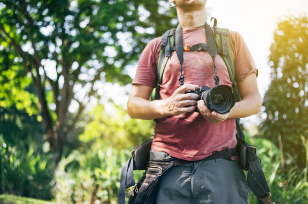Adventurous photographer with camera in the jungle - Photo, Image