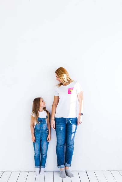 Girl of European appearance with long blond hair, smiling, mother and daughter, communication, family - Foto, immagini