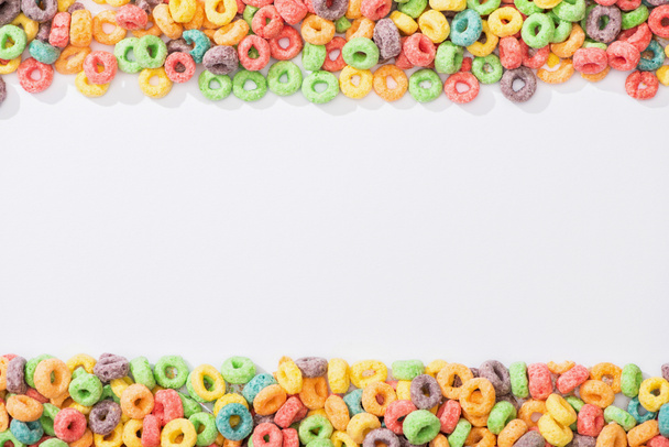 top view of bright multicolored breakfast cereal on white background - Photo, Image